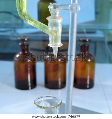 A yellow substance dropping from a burette in a chemistry lab.