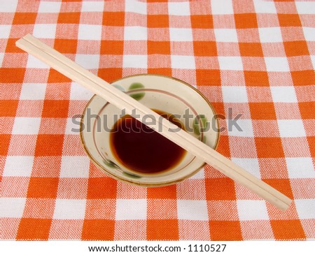 Soy sauce and ordinary chopsticks on a Japanese home table.