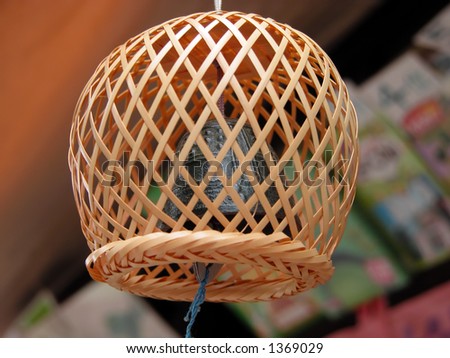 Specific Japanese bell decoration, covered by a bamboo wood net.