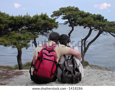A couple with backpacks admiring an ocean-scape from a calcareous island-Matsushima,Japan