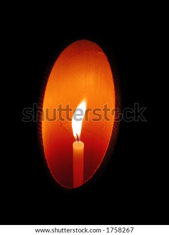 A candles in a bamboo wooden candlestick in the night