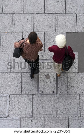 Two senior Japanese women walking in a city street-upper view