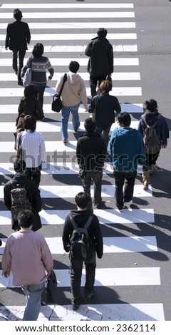 Group of people crossing the street-upper view during the midday.