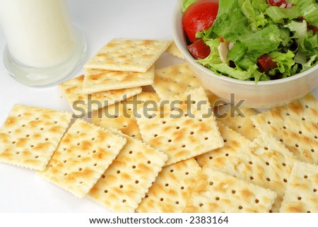 Crackers, vegetables salad and a glass of milk can be a very good choice for a healthy low calories breakfast.