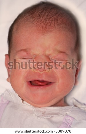 Portrait of 3 weeks old baby girl crying.