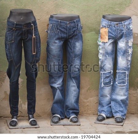 Blue jeans on manequins in an old town street.