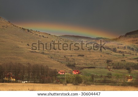 Beautiful rainbow just after the storm in a mountainous rural area.