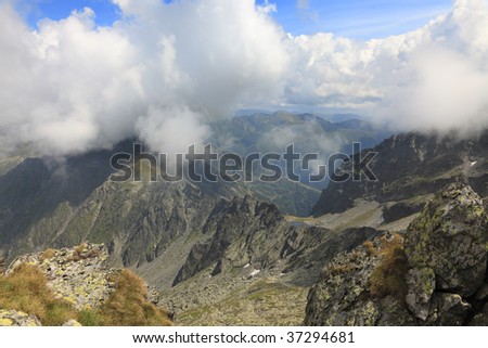 Clouds,rocks and beauty in Fagaras mountains,Romania.In the distance you can se Caltun Lake.