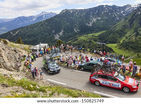 PORT DE PAILHERES,FRANCE- JUL 6: Row of technical cars of various cycling teams climbing the road to Col de Pailheres in Pyrenees Mountains during the stage 8 of Le Tour de France on 6 July 2013.