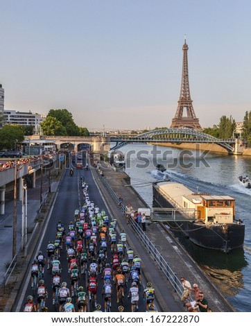 PARIS,JUL 21:The peloton riding on the Seine riverside near the Eiffel Tower during the last stage of the 100th edition of Le Tour de France on July 21, 2013 in Paris