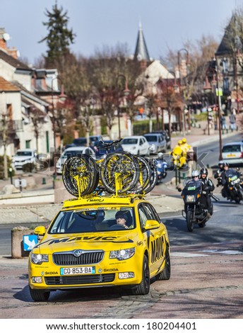 SAINT-PIERRE-LES-NEMOURS,FRANCE,MARCH 4: Row of technical teams cars during the first stage of the famous road bicycle race Paris-Nice, on March 4, 2013 in Saint-Pierre-les-Nemours