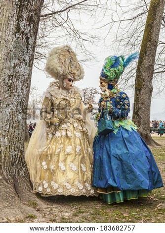 ANNECY, FRANCE,MAR 15:Two people disguised discuss in a forest in Annecy,France,on March 15 2014.Every year here is held a Venetian Carnival to celebrate the beauty of real Venice.