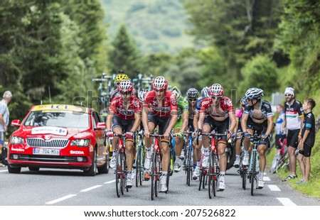COL DU TOURMALET, FRANCE - JUL 24, 2014:Three cyclists from Lotto Belisol Team lead a part of the peloton on the road to Col de Tourmalet in the stage 18 of Le Tour de France on July 24, 2014.