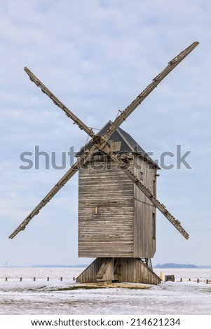Traditional wooden windmill during the winter, located in the Eure&Loir region of France.This windmill is \
