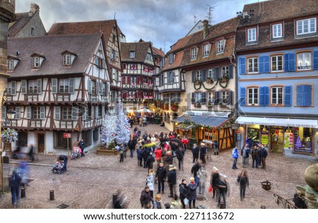 COLMAR,FRANCE-DEC 6:People walking in a square with traditional half-timber houses and Christmas decorations in Colmar, France on December 6, 2013.Colmar is the capital of Alsatian wine.
