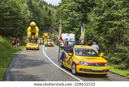COL DU PLATZERWASEL,FRANCE - JUL 14:The caravan of LCL vehicles during the passing of the Publicity Caravan on the road to Mountain Pass Platzerwasel, during Le Tour de France on July 14 2014