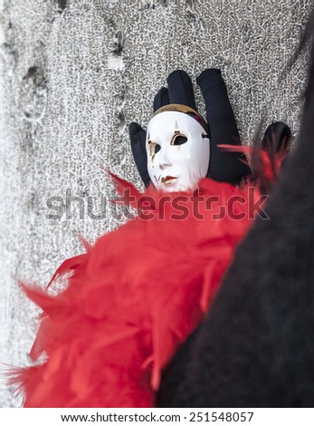 VENICE-FEB 2012:Close-up image of a little white mask on a hand of a disguised person in San Marco square on 18 February 2012 in Venice. In 2015 the Venice Carnival is between January 31-February 17