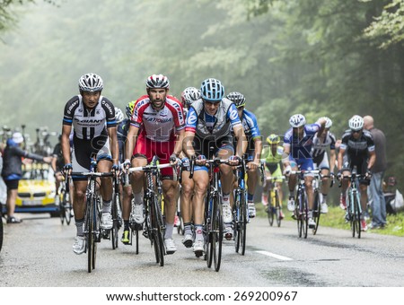 COL DU PLATZERWASEL,FRANCE - JUL 14: The peloton on the climbing road to mountain pass Platzerwasel in Vosges Mountains, during Le Tour de France on July 14 2014