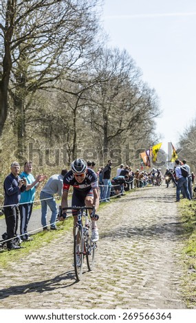 TROUEE d\'ARENBERG, FRANCE- APR 12: The cyclist  Aleksejs Saramotins of IAM Cycling Team cycling on the cobblestone road from the forest of Arenberg in the Paris Roubaix 2015 race.