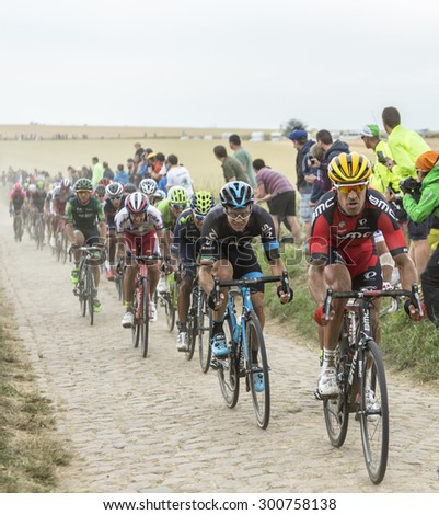 QUIEVY,FRANCE- JUL 07: Manuel Quinziato (BMC) and Nicolas Roche (Team Sky) riding in front of a cyclists on cobblestone road during the stage 4 of Le Tour de France on 07 July,2015 in Quievy, France.