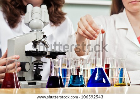 Lab workers working with chemical lab equipment