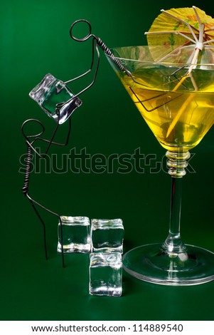 Two funny characters made of wire loading ice cubes into cocktail glass