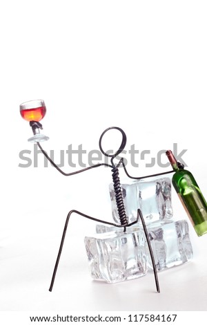 Wire character parting on ice cubes with wine glass and a bottle