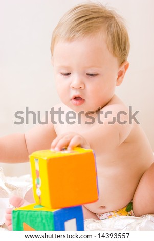 Cute little boy with soft cubes toy