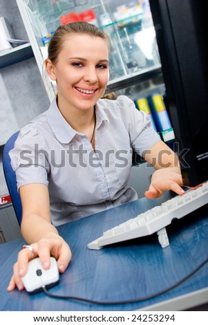 Beautiful smiling girl working on desktop PC