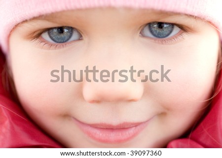 Adorable little girl with blue eyes smiling