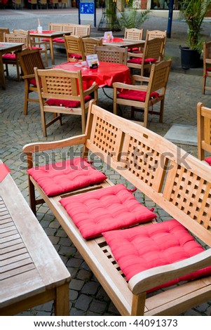 Comfortable wooden furniture in european street cafe