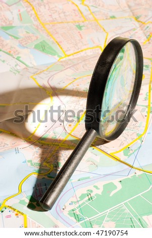 Magnifying glass on city map