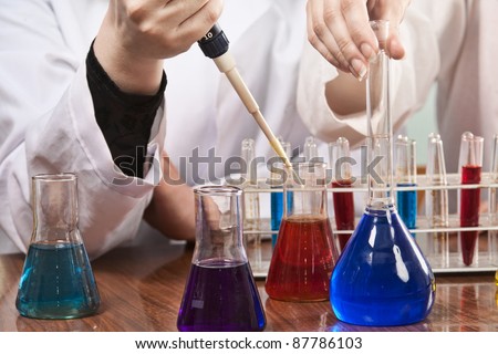 Woman working with chemical lab equipment