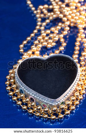 Open heart shaped jewel box with golden beads