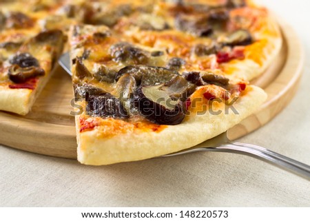 Italian  pizza lifted slice with mushrooms, mozzarella and parmesan