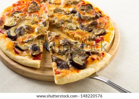 Italian  pizza lifted slice with mushrooms, mozzarella and parmesan