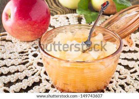 Homemade apple jam on  wooden board on background fresh ripe apples