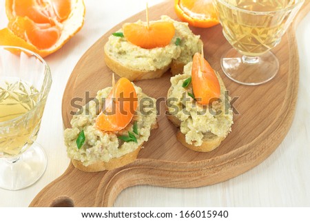 Creamy pate served with french bread and mandarins
