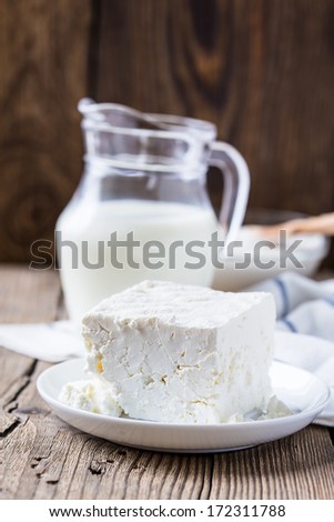 Dairy milk products: cheese and milk on rustic wooden background