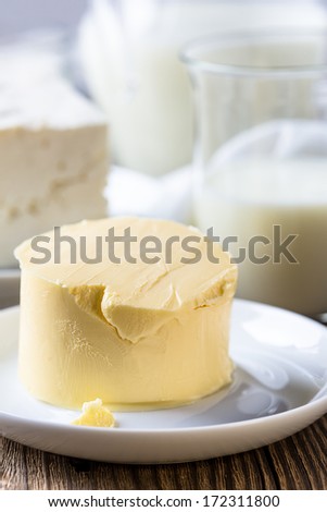Dairy milk products: butter, cheese and milk on rustic wooden background