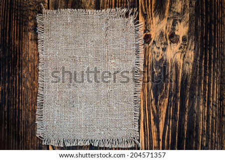 Burlap on vintage wooden table  view from top. Rustic background with free text space