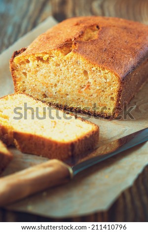 Homemade pound cake baked in a loaf pan on a wooden board