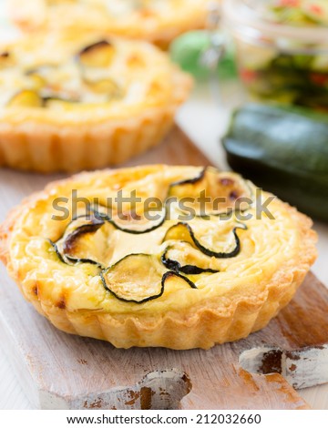 Traditional french quiche, tart with cheese and sliced small zucchini