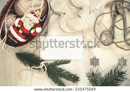 Christmas preparation handmade (craft) Christmas  decorations on white wooden desk viewed from above with copy space and a sheet of blank paper for holiday message