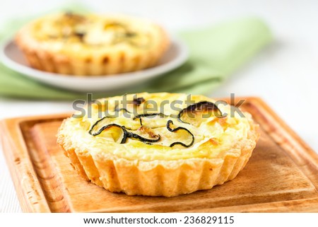 Traditional french quiche, tart with cheese and sliced small zucchini