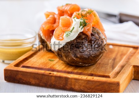 Crispy jacket potatoes with light soft cheese and smoked salmon fillet  toppings