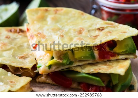 Homemade quesadilla,  corn tortilla filled with cheese,  avocado, chopped onion, and  chiles