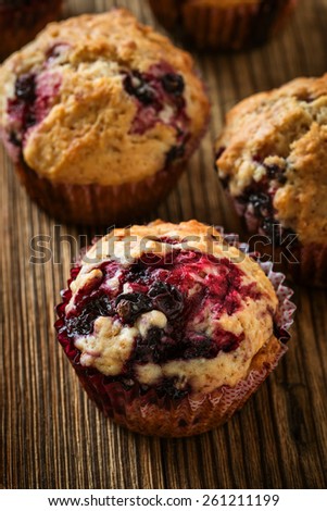 Homemade black berry muffins. Muffins with black currant for healthy breakfast on rustic wooden table