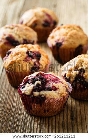 Homemade black berry muffins. Muffins with black currant for healthy breakfast on rustic wooden table