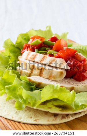 Homemade lettuce wrapped chicken fajitas served  on a flour tortilla with tomato salsa